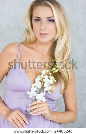 Blond girl with orchid in studio shot