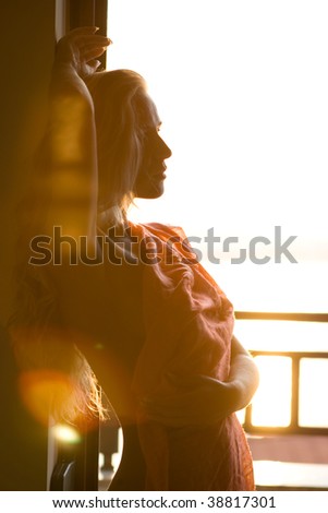 Beautiful young blonde girl posing in sunset light