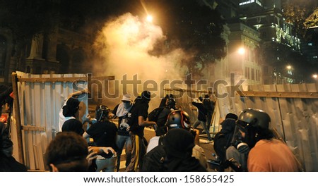 RIO DE JANEIRO, BRAZIL - OCTOBER 15:  protesters are surrounded by tear gas on a barricade along the city center main avenue, Rio Branco, in support to the teacher\'s strike as the annual October 15 Teachers\' Day holiday came to a violent conclusion on Oct