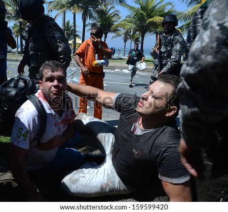 RIO DE JANEIRO, BRAZIL - 21 OCTOBER 2013: Oil workers demonstrators wounded by  bullet gun fired by the National Force Security Battalion screams in pain