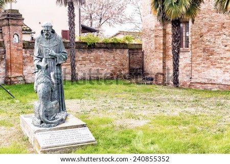 The statue represents the meeting of Saint Francis and the wolf and itÃ?Â¢??s located in the garden at the entry of the XV century roman gothic church dedicated to Saint Francis in Cotignola in Italy