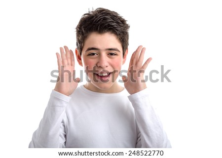Happy Caucasian smooth-skinned boy in a white long sleeved t-shirt smiles waving open hands along the sides of the face