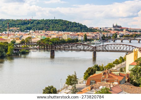 View of Prague from the Vltava river: house, trees, buildings and historical palaces