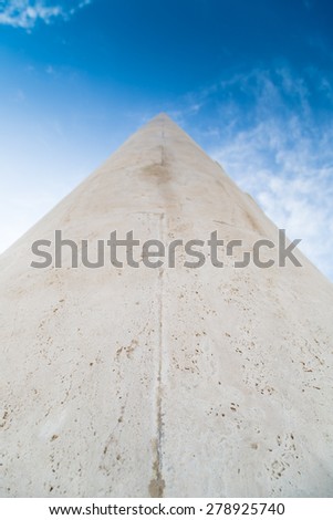 A long stone tip going to vanishing point at the horizon on a sky background