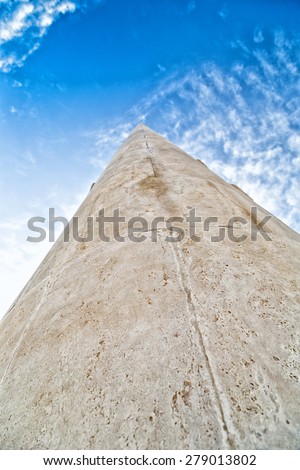 A long stone tip going to vanishing point at the horizon on a sky background