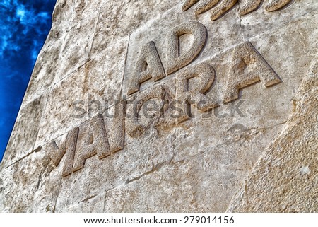 The latin sentence Ad maiora set in stone in capital letters, means literally to greater things and then in pursuit of excellence.