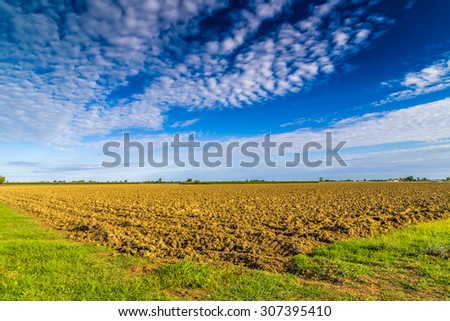 plowed and tilled field with bare clods of earth in the Italian countryside