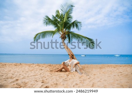 Similar – Image, Stock Photo Lady sitting on sandy coast near sea