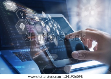Business technology, IoT Internet of Things, Software development concept. Business man, working on digital tablet, laptop computer. Coding programmer developing mobile apps. Web icons, computer code 商業照片 © 