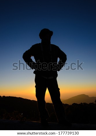 Silhouette of a man on the sunrise background.