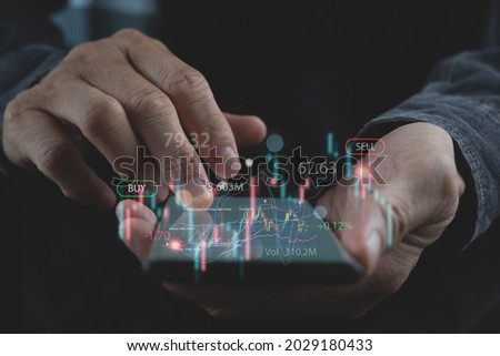 Business, finance and investment, forex trading, currency exchange, economic growth, stock market analysis concept. Man using mobile phone checking stock market graph report via mobile apps