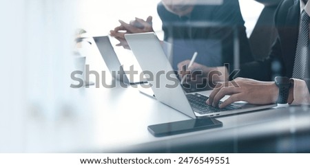 Image, Stock Photo Two business people discussing financial data looking at computer screen. Entrepreneurs working hard sitting at computere screen in office. People having deadline working together