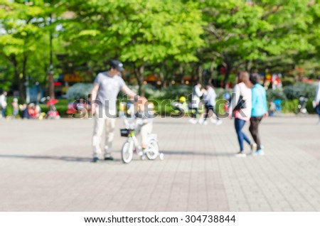 Blurred background of people activities in park, spring and summer season