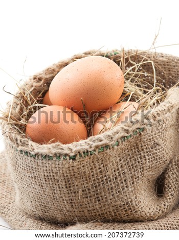 The eggs in a sack with a piece of grass pad on white background