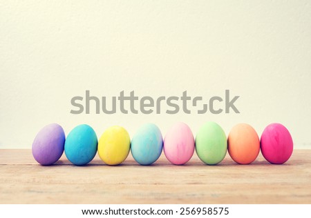 Vintage colorful easter eggs on wood table empty background