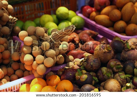 Tropical fruits at the evening market. At sunset. Thailand.