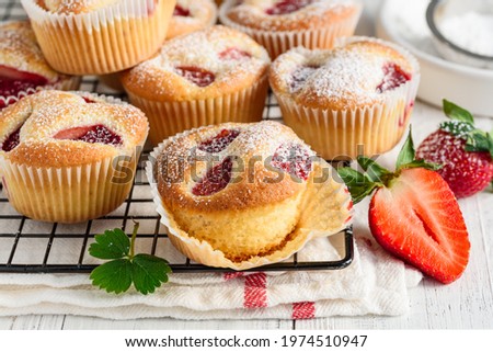 Similar – Image, Stock Photo Eating a strawberry muffin. Woman hands holding a muffin. Fruit dessert