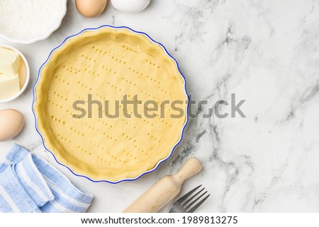 Dough for baking quiche tart pie in ceramic form. Culinary concept. Flat lay. Сopy space Stok fotoğraf © 