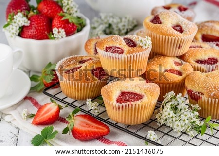 Similar – Image, Stock Photo Eating a strawberry muffin. Woman hands holding a muffin. Fruit dessert