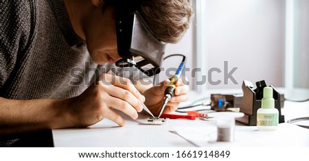 Similar – Image, Stock Photo Crop man fixing microchip in workshop