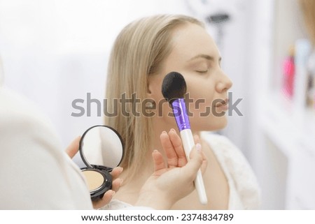 Similar – Image, Stock Photo Professional visagiste applying powder on model face