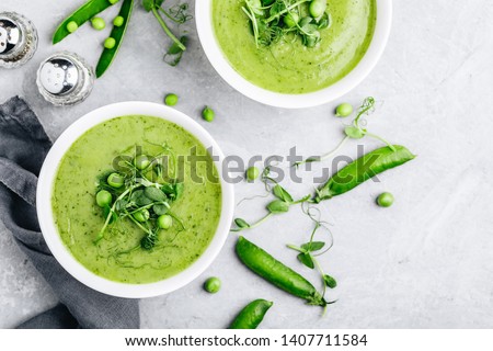 Summer cream soup with green fresh pea shoots. Top view Foto stock © 
