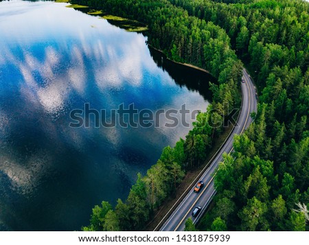 Similar – Image, Stock Photo River between green trees with view of wind turbine and power pole, energy turnaround