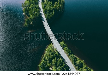 Similar – Image, Stock Photo Aerial view over a little town with wind wheels and a lake in the background of a german countryside.