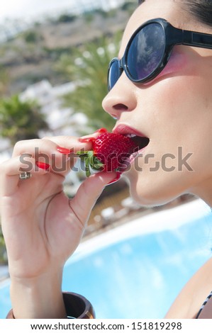 sexy woman eating strawberry