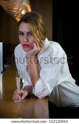 woman having a drink or a glass of champagne