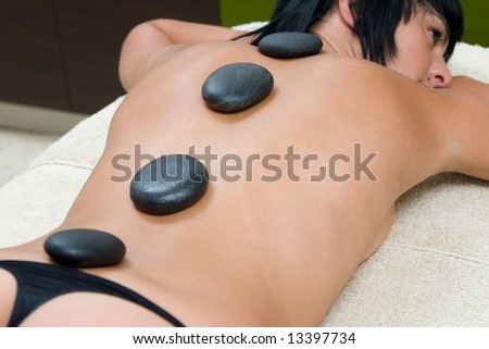 woman in a relax position with stones massage