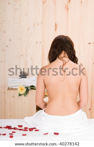beautiful woman back in a sauna or massage cabin
