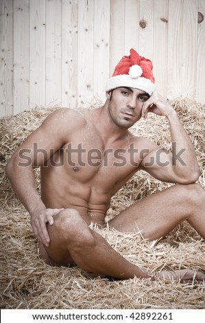 sexy muscled male santa claus vintage sitting in his barn