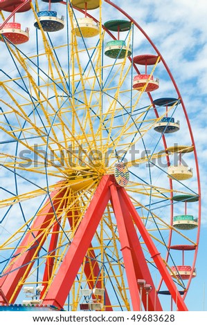 ferris wheel with blue sky in amusement park