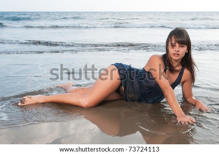 beautiful woman at the seaside with wet clothes