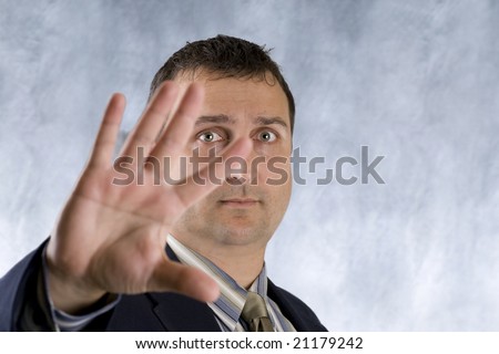 Man putting his hand out to stop the photographer.