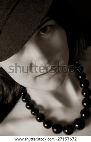 Beautiful black and white  image of an attractive woman wearing a chunky black necklace.