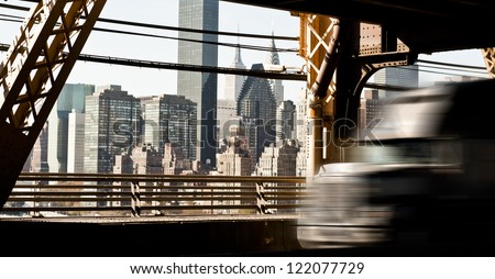 American Truck speeding on the Queens bridge, New York Downtown in the background