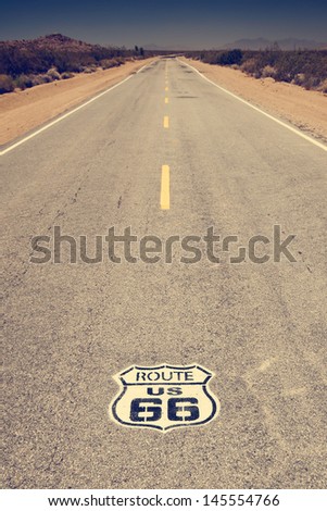 Route 66 pavement sign with Mojave desert