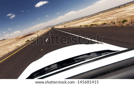 Car ride on road in Nevada desert, USA - view from the top of the car