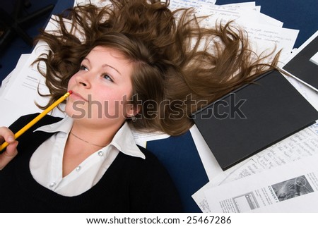 Portrait of natural young girl when taking a break while learning studying with pencil in mouth