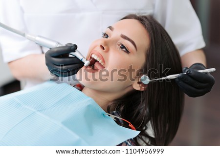 Similar – Image, Stock Photo Dentist treating teeth of patient with UV light