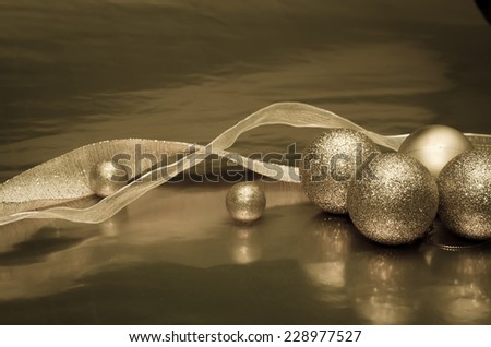 shining golden ribbon with golden balls over golden background