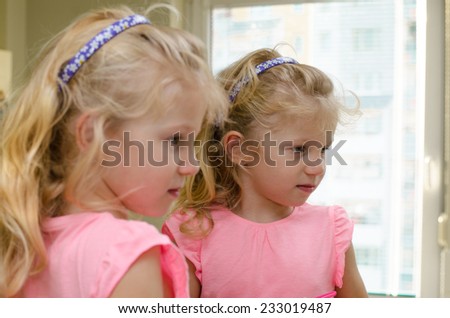 beautiful blond girl  reflection in the mirror