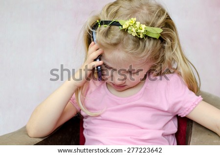 blond girl listening to someone in mobile phone