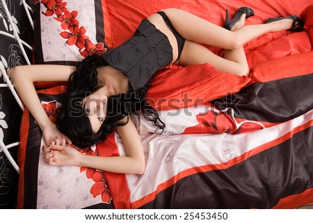Young brunette woman on the bed