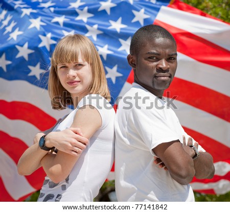 White girl and black guy outdoors. White girl and black guy against American flag