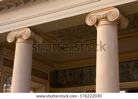 Closeup of two ionic columns in renaissance architecture.