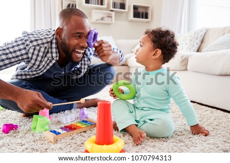 Image, Stock Photo Ethnic father playing with child on ground