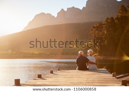 Romantic Senior Couple Sitting On Wooden Jetty By Lake Сток-фото © 